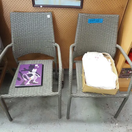 pair of woven plastic outdoor armchairs