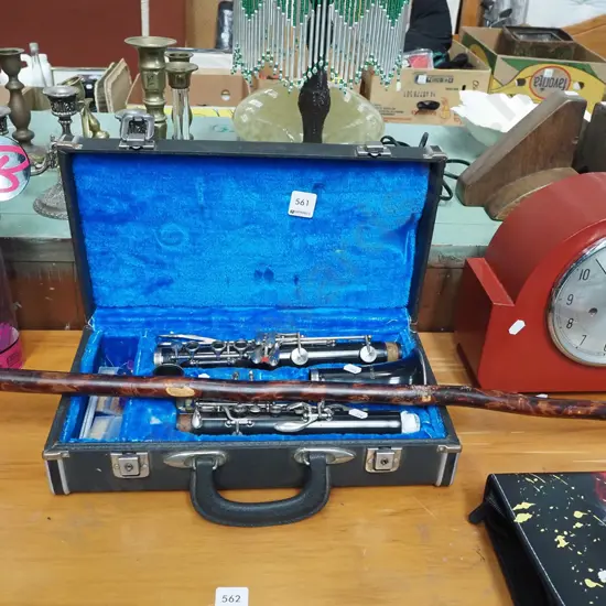 cased Swallow brand clarinet and a walking stick