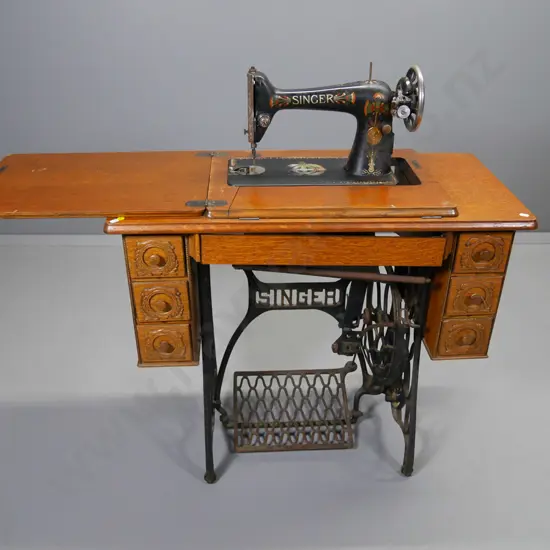 vintage oak-cased Singer sewing machine, no belt, treadle needs work, some damage to tilt drawer H780 W860 D400