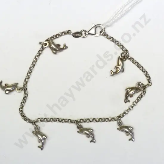 silver charm bracelet with 7 dolphin charms stamped 925
