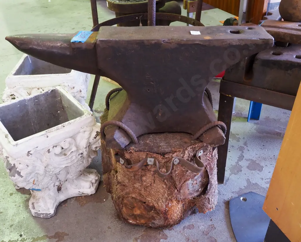 blacksmith's anvil on tree trunk base W700 Image 1++