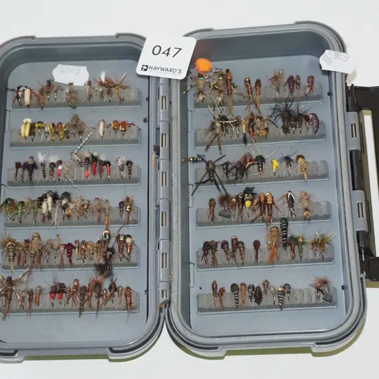 container of fly fishing flies