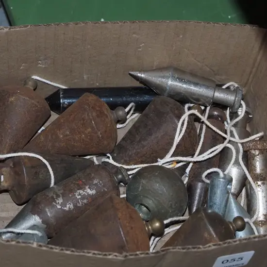 box of vintage plumb bobs
