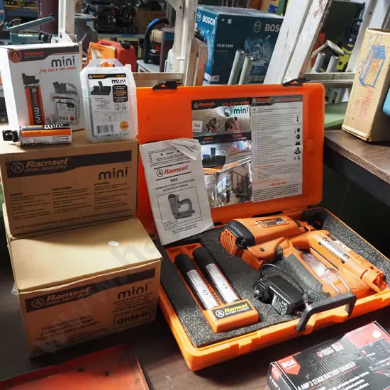 cased Ramset mini nail gun with 3 boxes of additional fuel cells and bars - batteries in office