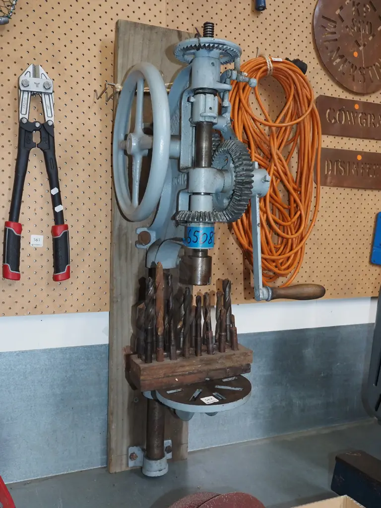 wall mounted hand cranked drill press with various bits Image 1++