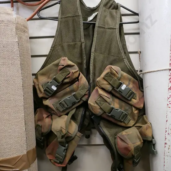 camouflage vest and numerous pockets