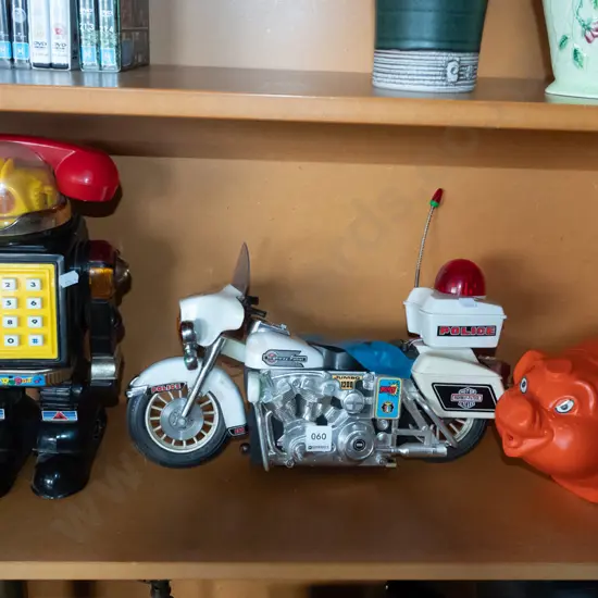 childrens toys; robot, piggy bank, damaged police motorcycle