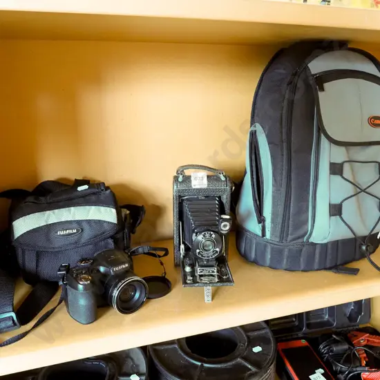Fujifilm digital camera, vintage Kodak folding camera, Canon camera bag