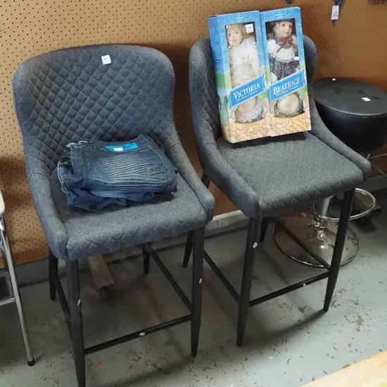 pair of grey upholstered bar stools