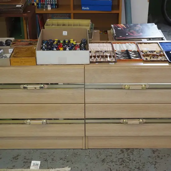 pair of 1980s mdf faux wood veneer 2 drawer chests, with brass stripes and handles
