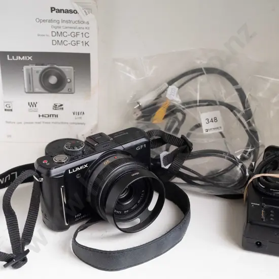 Lumix GF1 digital mirrorless camera with 20mm f/1.7 lens, charger and manual