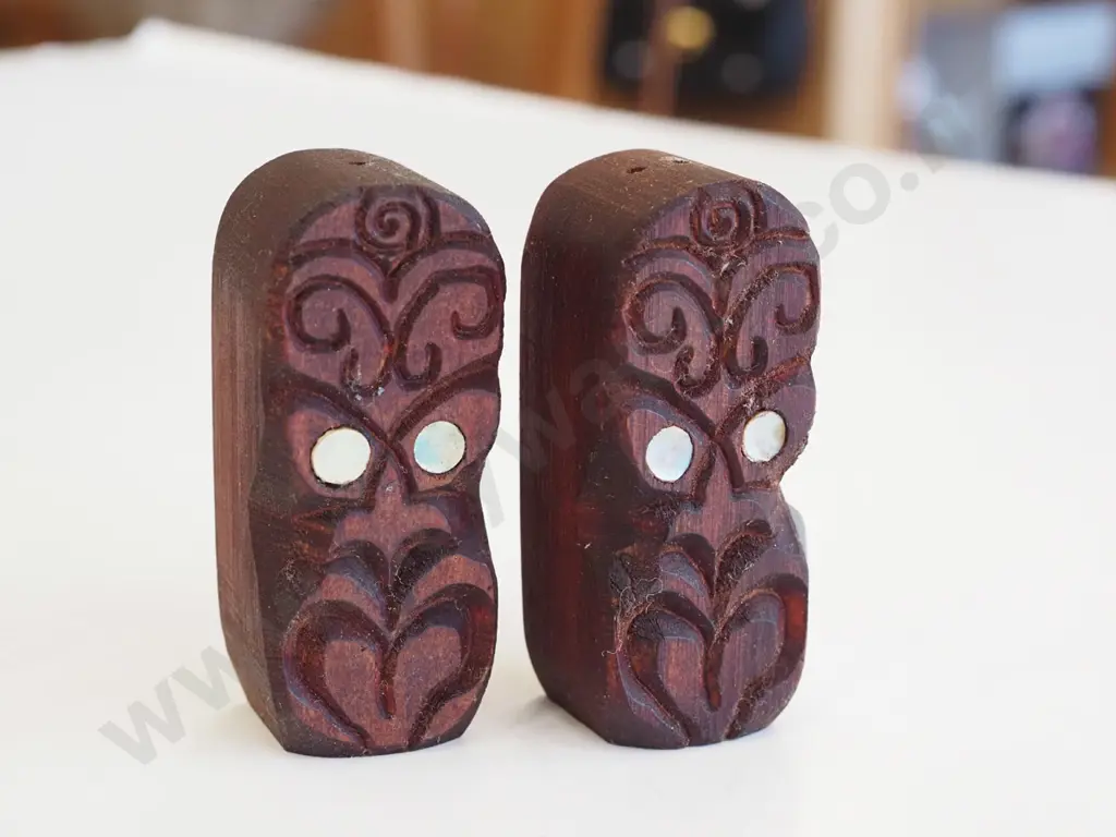 pair of carved tiki themed salt and peppers Image 1++