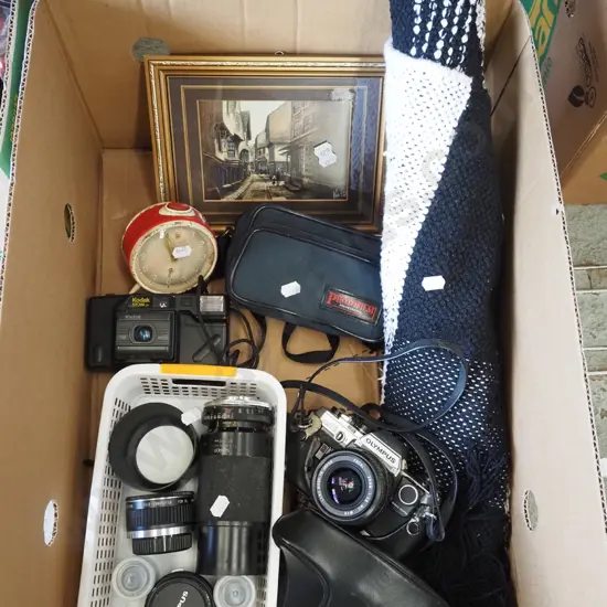 box; Olympus 35mm camera, lenses, alarm clock etc