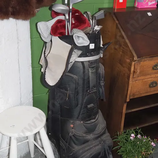 golf clubs and bag and trundler