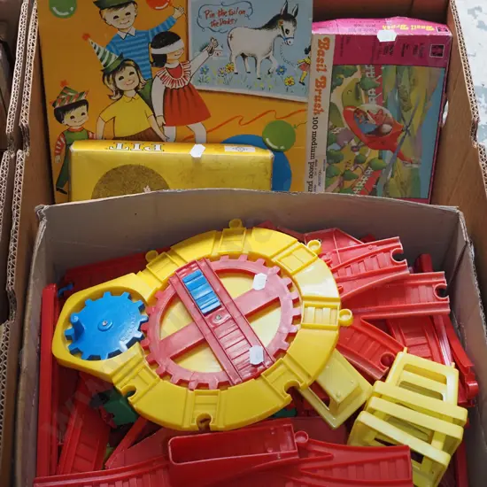 box; plastic train set, puzzles, board games