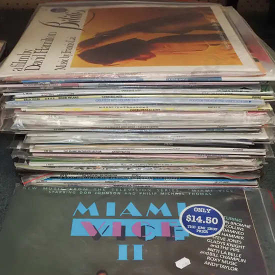 stack of LPs; Miami Vice sound track, Crystal Gale etc