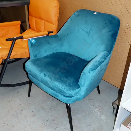 teal upholstered armchair