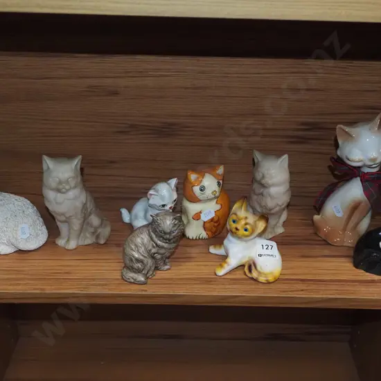 shelf of cat figurines