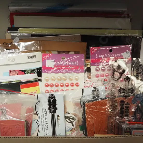 box of crafting supplies, tracing paper, cards, beads etc