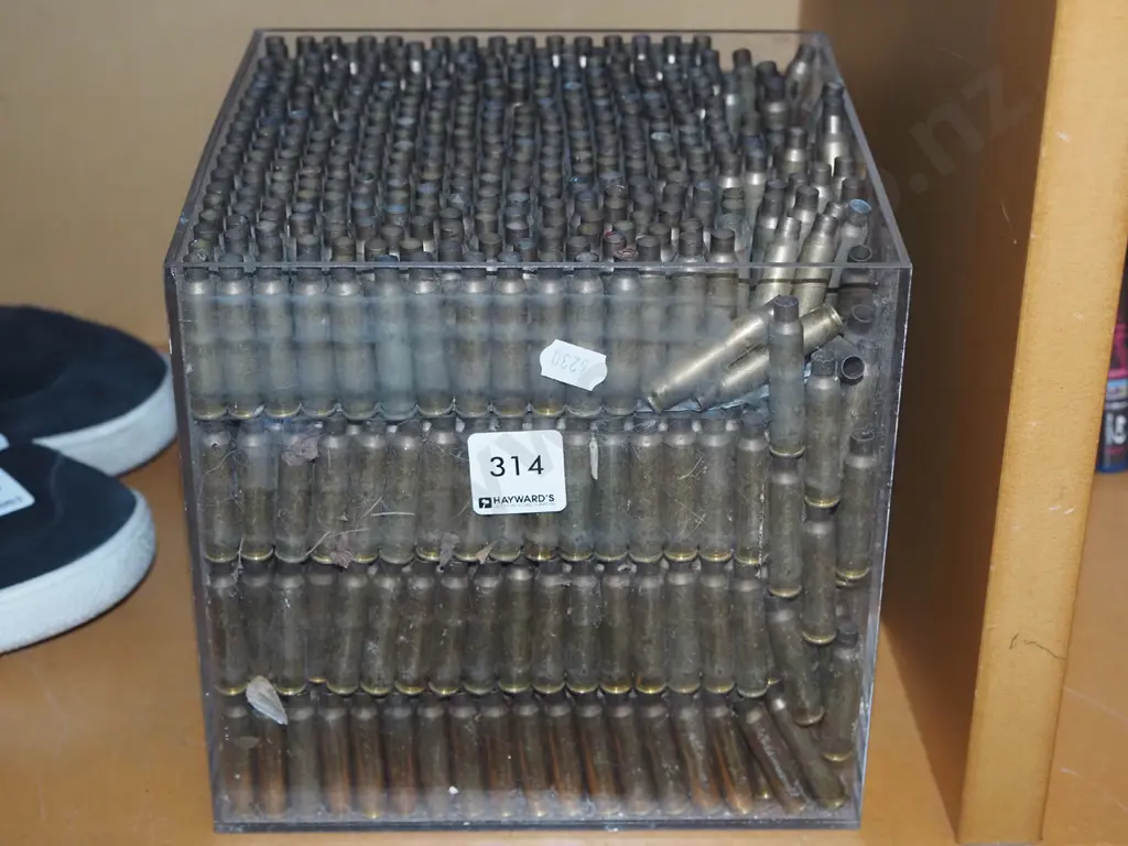 copper shell casings in clear perspex box Image 1++