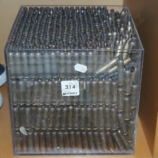 copper shell casings in clear perspex box