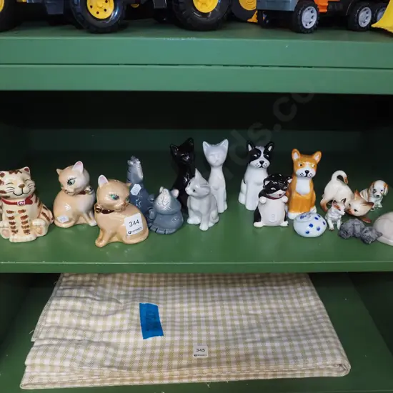 shelf of cat figurines, salt and peppers