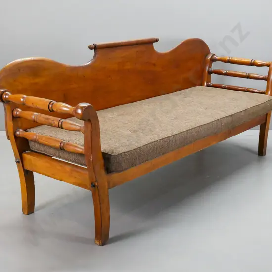 colonial rimu shearer's couch with rolling pin back, rolled and turned ends, foam squab on slatted base. Splits to