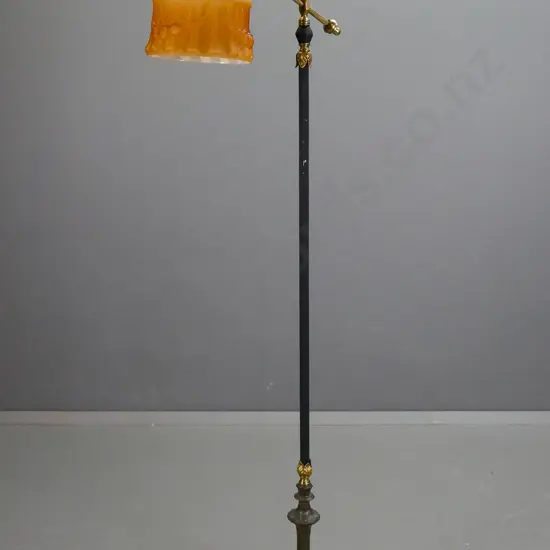 retro brass standard lamp with black painted column and fluted base, angled top bar with bird motif, small amber glass