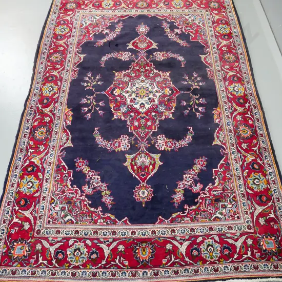 Persian style wool floor rug - dark reds and blues - some wear and indentation, some missing fringe L-2160 W-1430