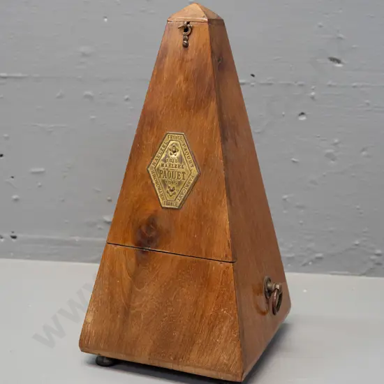 vintage timber-cased metronome Maelzel Paquet France. Working. Some fading and staining to timber, minor crack to case.
