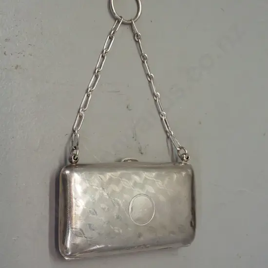 Small sterling silver coin purse w/leather interior and chain handle. Some scratches and dents. H-55 W-95