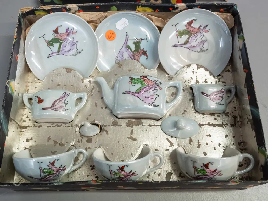 boxed child's tea set with witch riding a goose motif - 3 cups & saucers, teapot, cream & sugar - wear to box Image 1++