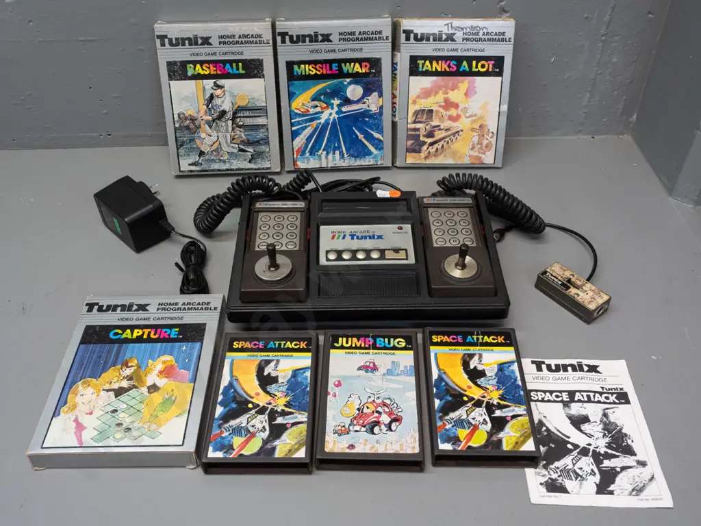 Tunix Home Arcade video game console with attached controllers, power supply, 7 game cartridges (some with boxes, Space Image 1++