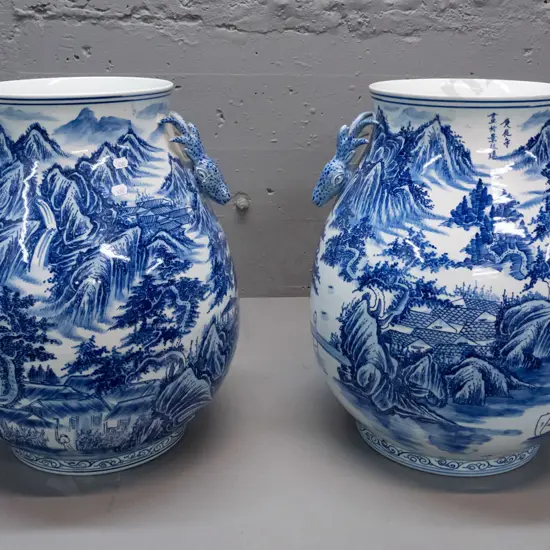 pair of large Chinese blue & white floor vases with flared rim, antelope head handles, landscape & village decoration.
