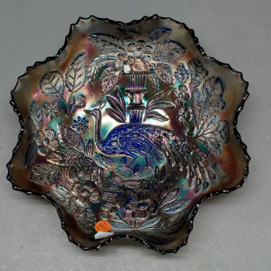 frilled rim carnival glass bowl in blue lustre peacock design, with hanging wire around base D-220