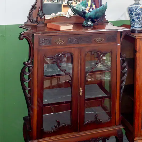 art Nouveau walnut parlour display case, pierced and carved pediment above shaped bevel edged mirror,