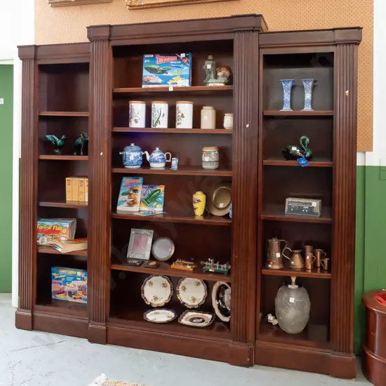 Regency style mahogany break-front bookcase in 3 sections, with fluted pilasters, adjustable shelves, centre section has