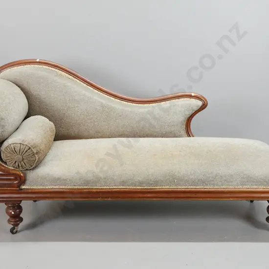 Victorian colonial cedar chaise longue with scrolling end, moulded shaped front on bun feet, grey fabric & bolster