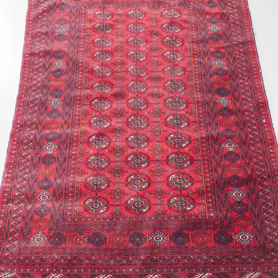 Turkoman style hand-knotted wool floor rug - dark reds and black, a few stains, minor wear, some loss of fringe L-1860