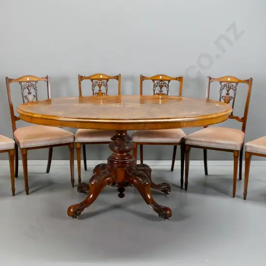 Victorian oval tilt-top table with walnut top, boxwood stringing & floral inlay, on 4-point carved elm pedestal base,