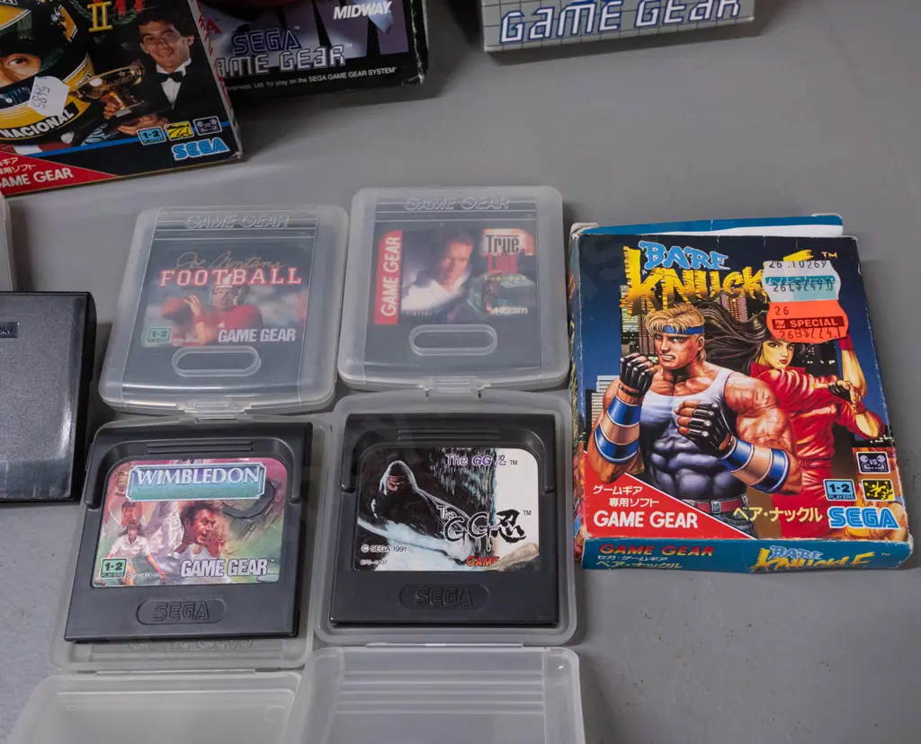 Sega Game Gear handheld game with 13 assorted cartridges, some boxed, some booklets - powers up, otherwise untested Image 1++