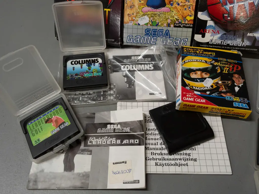 Sega Game Gear handheld game with 13 assorted cartridges, some boxed, some booklets - powers up, otherwise untested Image 1++