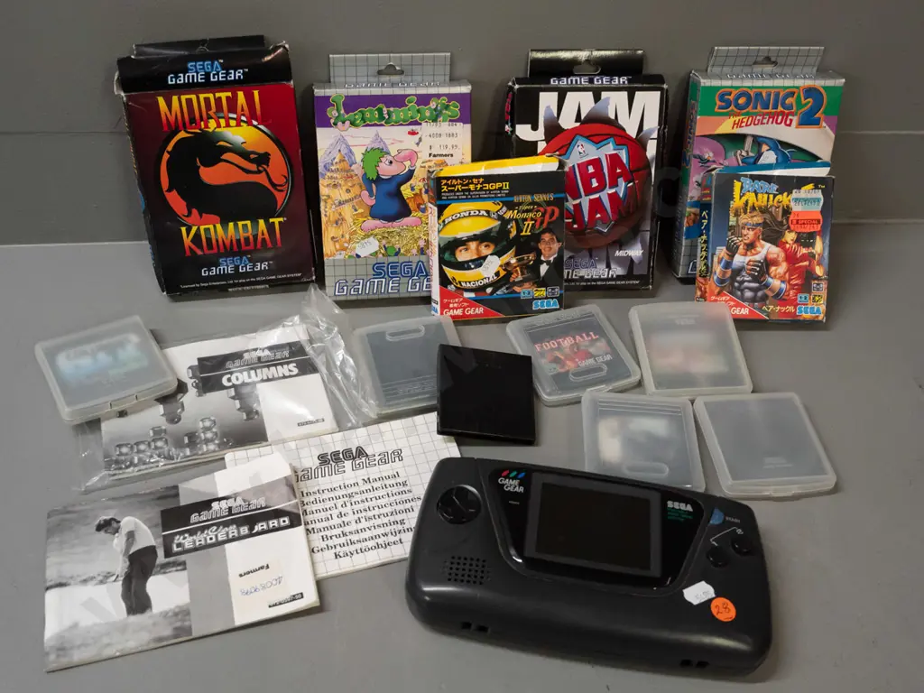 Sega Game Gear handheld game with 13 assorted cartridges, some boxed, some booklets - powers up, otherwise untested Image 1++