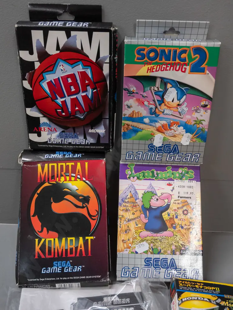 Sega Game Gear handheld game with 13 assorted cartridges, some boxed, some booklets - powers up, otherwise untested Image 1++