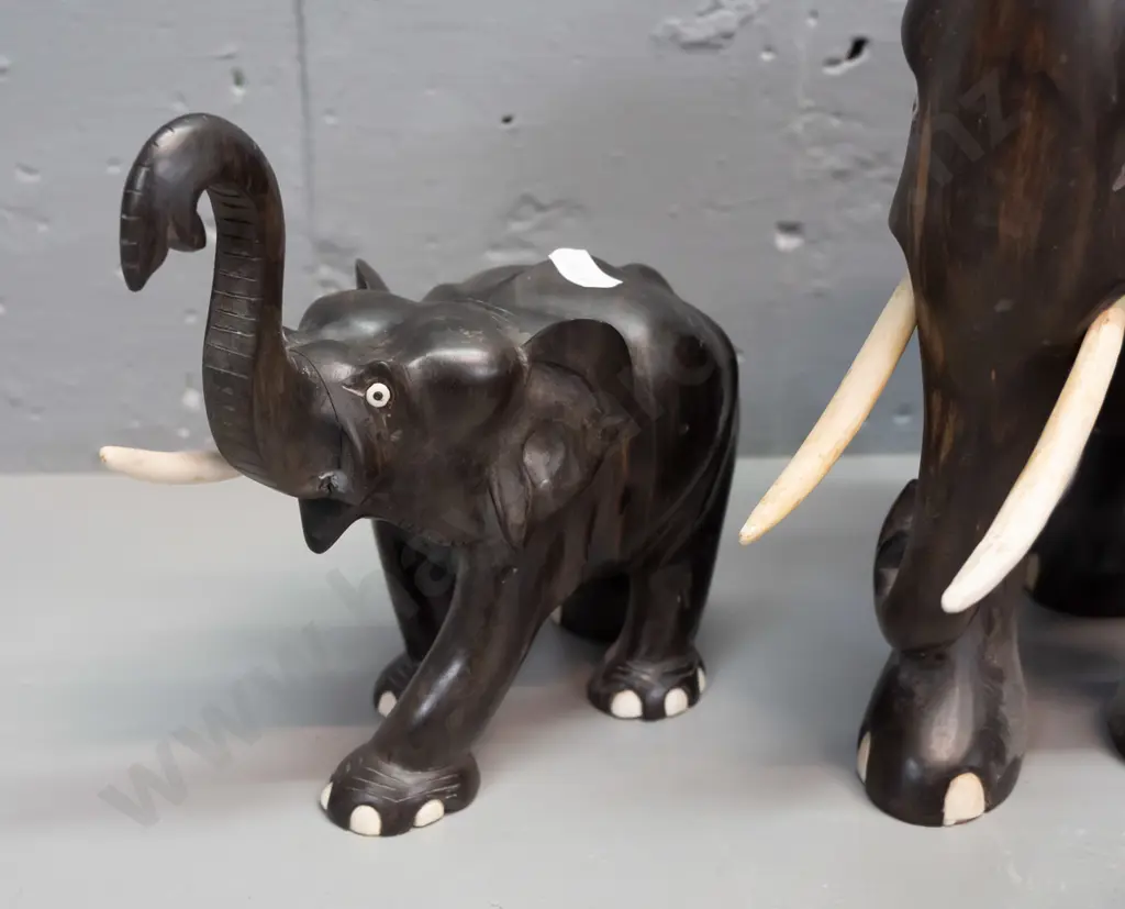 4 carved ebony elephants, varying styles - largest has crack through middle, one is missing eyes, one missing a tusk. Image 1++