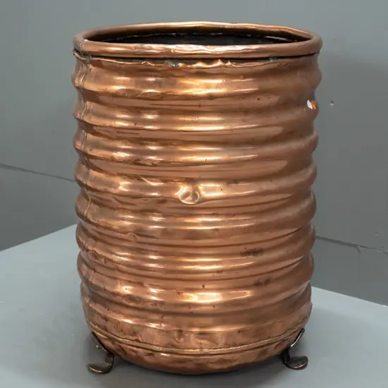 ribbed copper wood bin on 3 cast metal feet, original plumbing hole patched on bottom - a few dents H-530 D-390