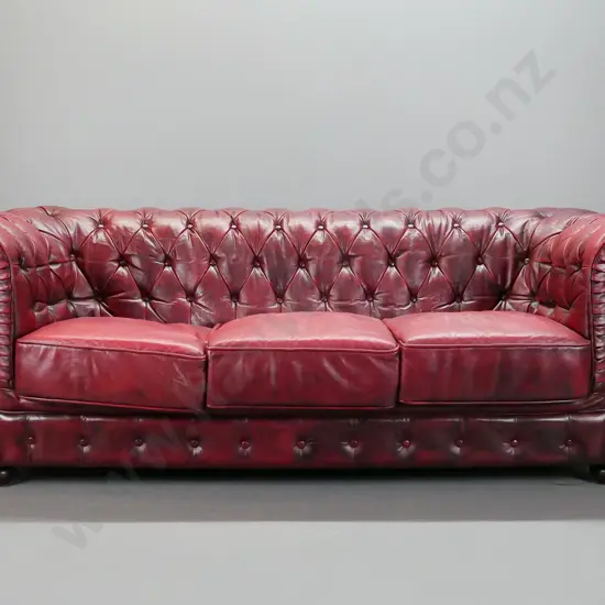 red leather rolled-arm 3-seater couch with deep button and pleated back and arms, brass studded front facing - with