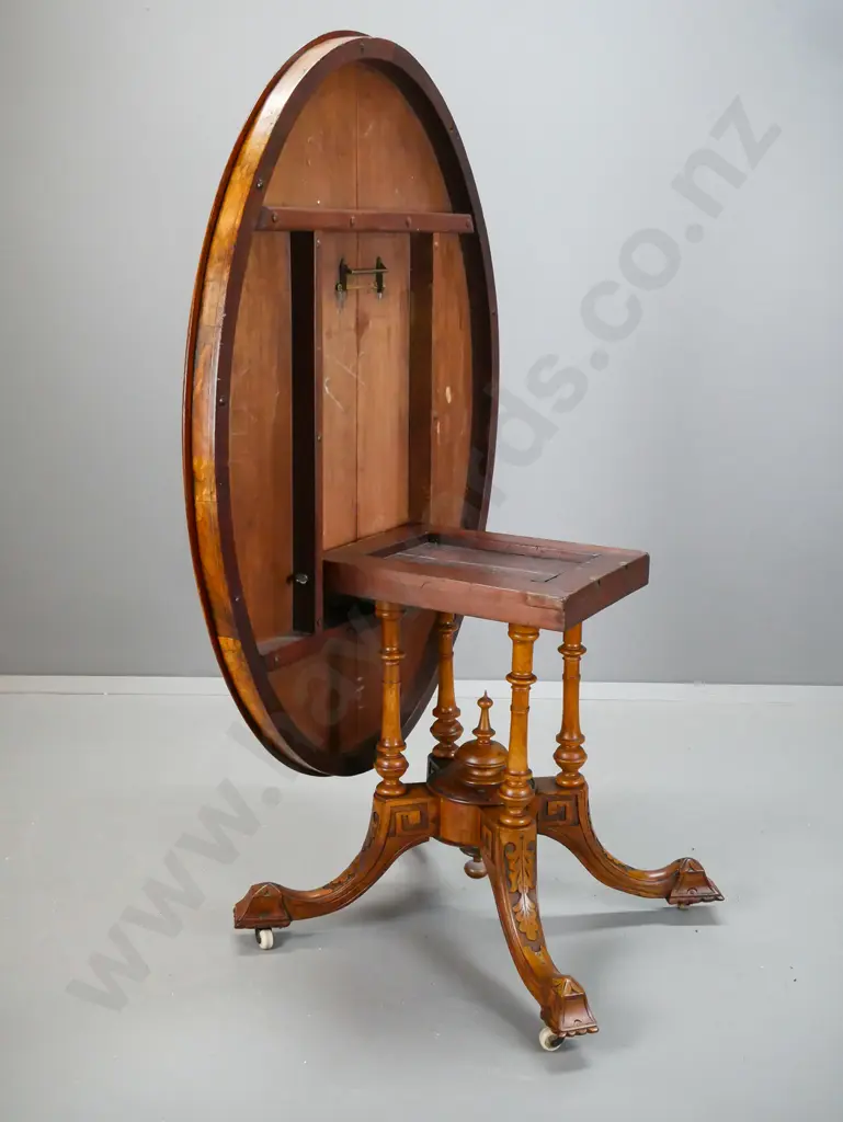 Victorian oval tilt top table with walnut top with boxwood inlay and stringing, on 4-point cathedral base, foliate Image 1++