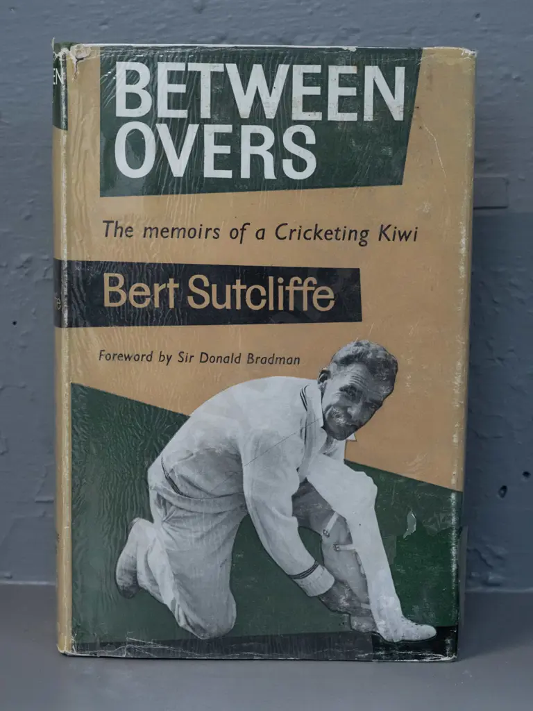 autographed hard cover book - Between Overs, signed by Bert Sutcliffe - see photo for details - some damage & Image 1++