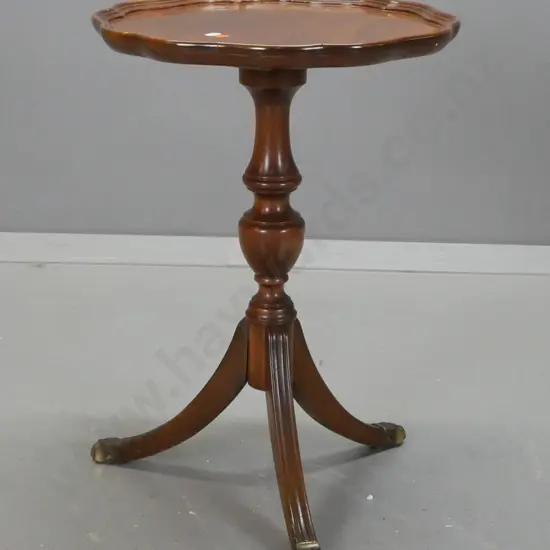 small reproduction wine table - walnut veneer top with shaped edge, beech base with brass paw feet - one loose leg, some